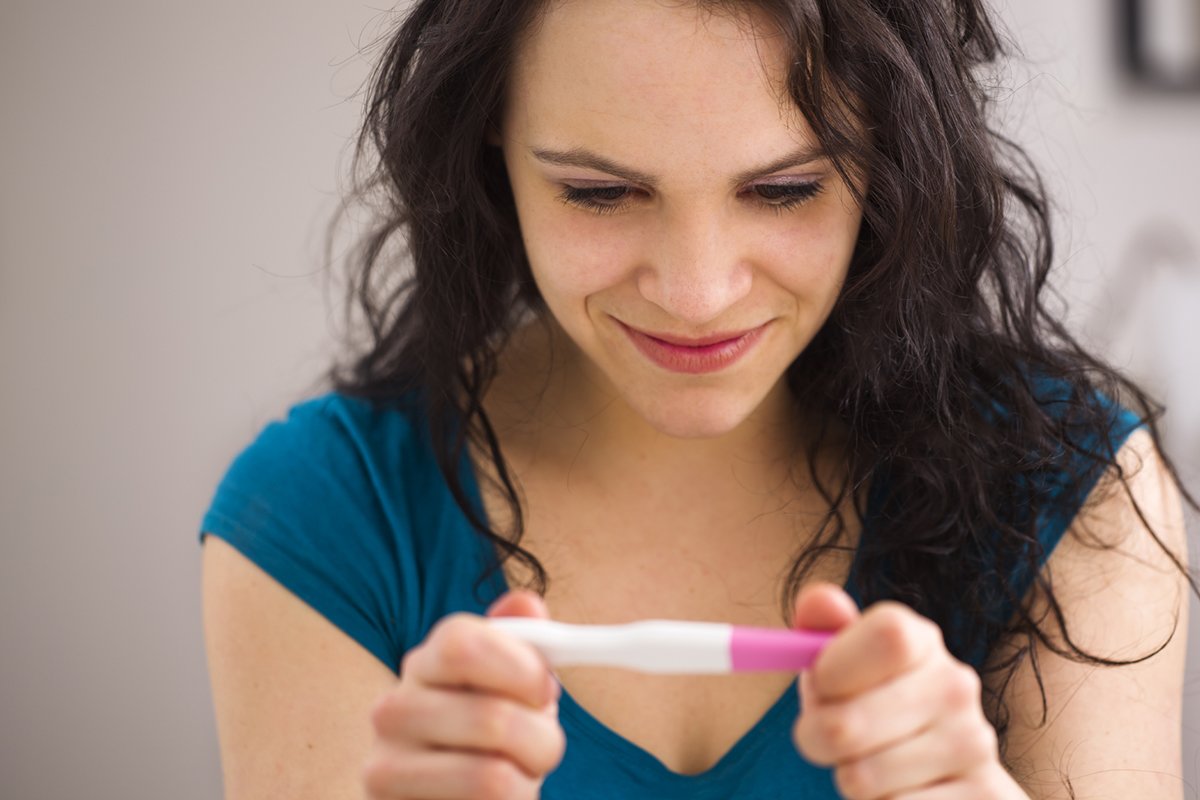 Infertility -- Woman looking at pregnancy test